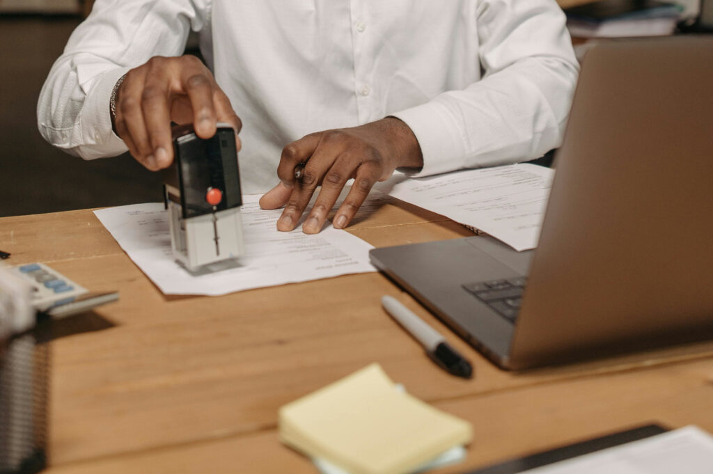 Woman stamping document with apostille notary seal